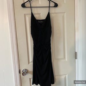 Black dress with adjustable front detailing.